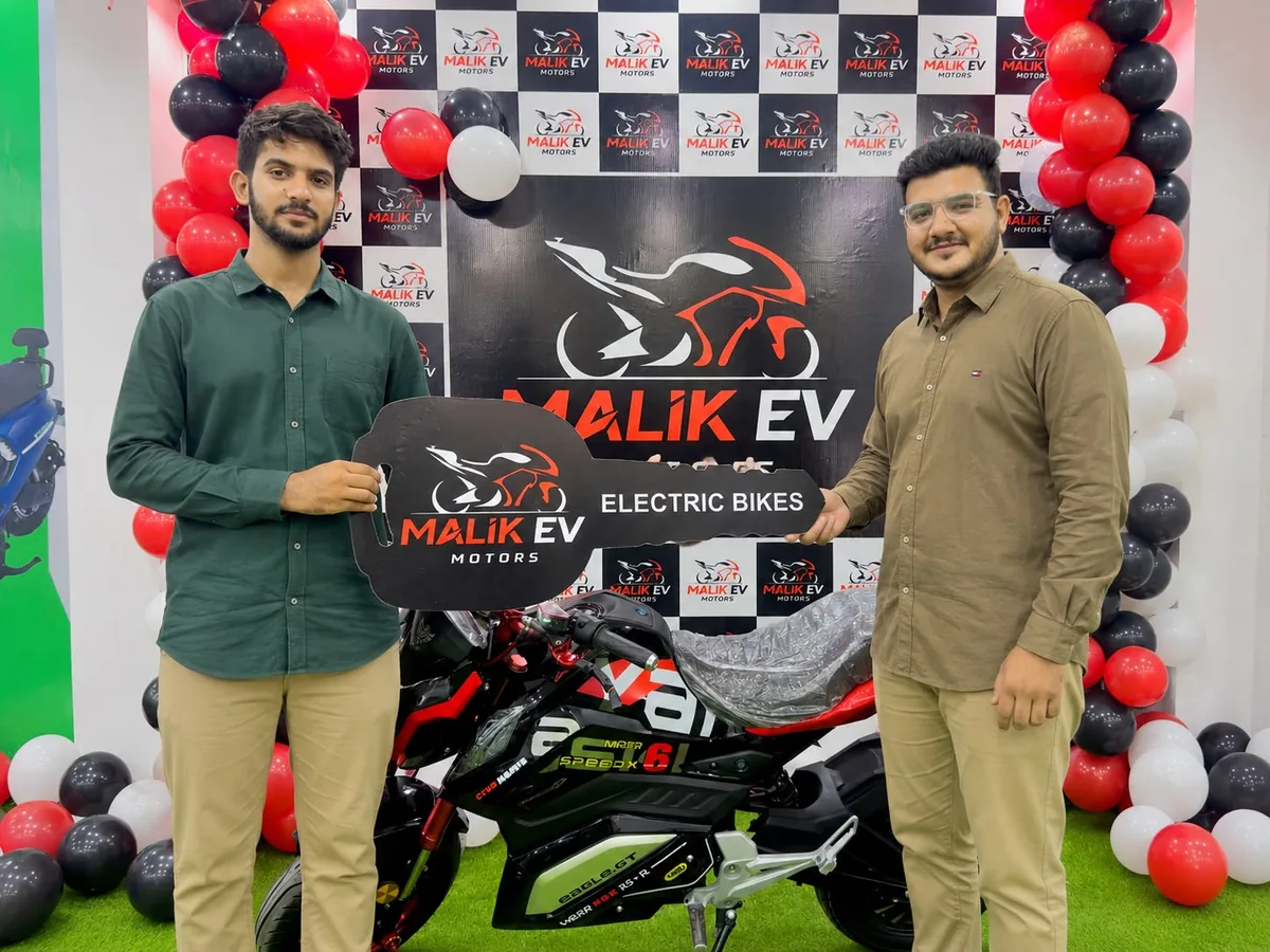 Malik EV Motors team handing over a new electric bike at the Green Town, Lahore showroom